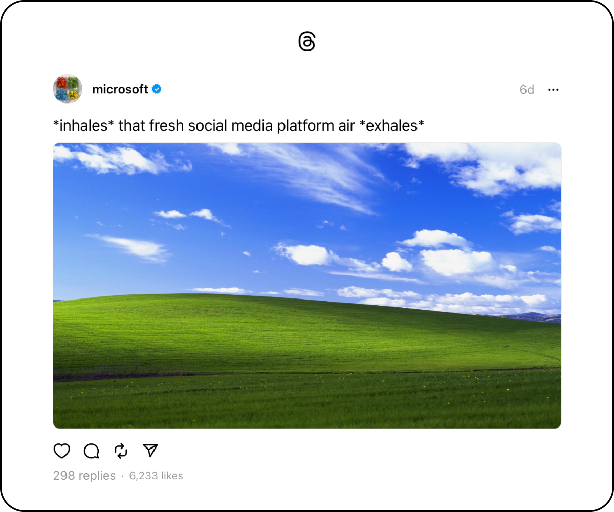 A Threads screenshot from microsoft that says "*inhales* that fresh social media platform air *exhales*" and a picture of the default windows background image of a field.