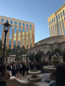 A crowd of people standing outside on a patio at Money 20/20 for Alloy's Women in fintech party
